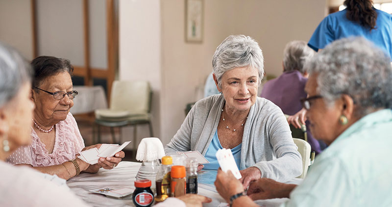 Group of senior women playing cards